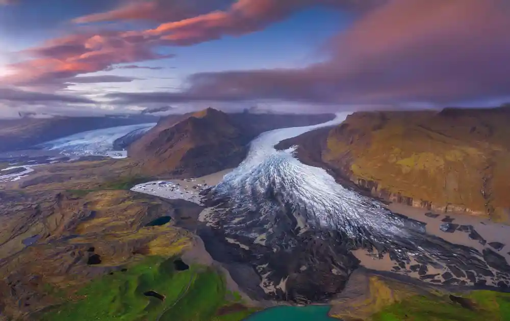 Aerial view of glacier valley with river and mountains