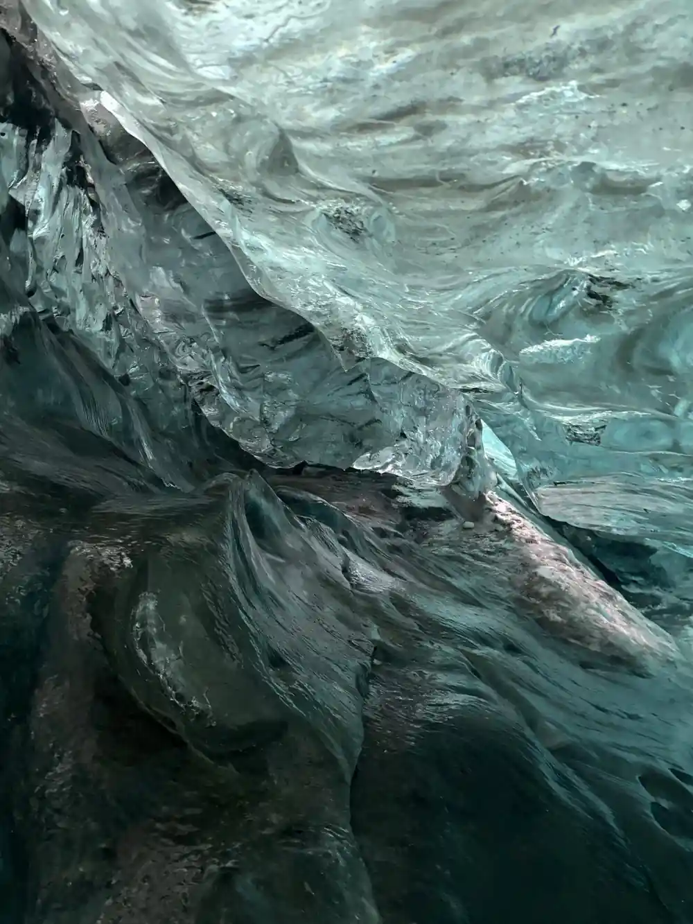 Darkening blue ice ceiling with layered striations