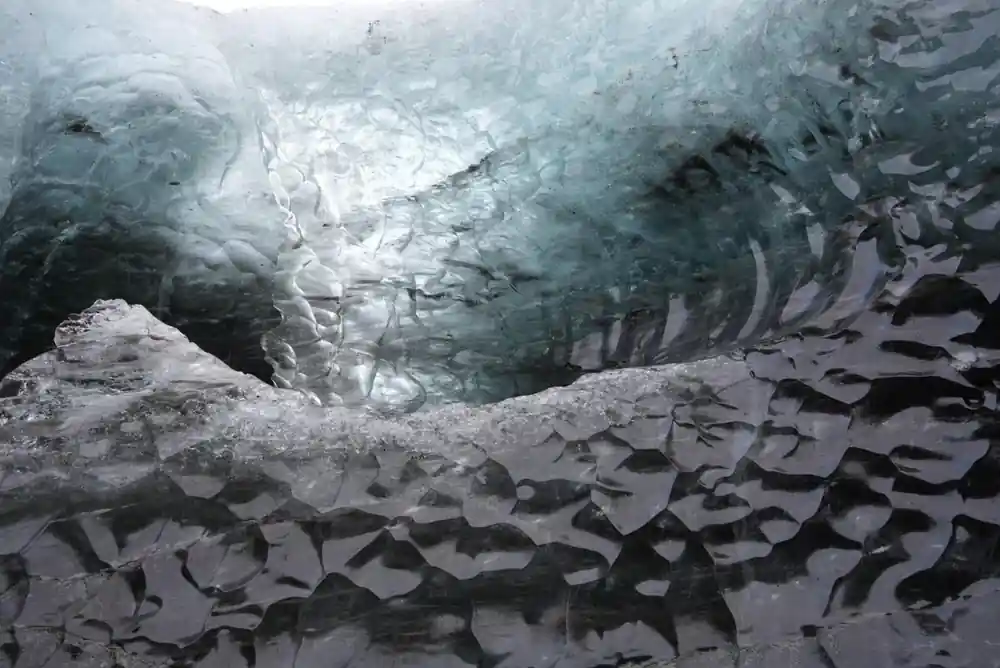 Hexagonal basalt columns in glacier ice cave