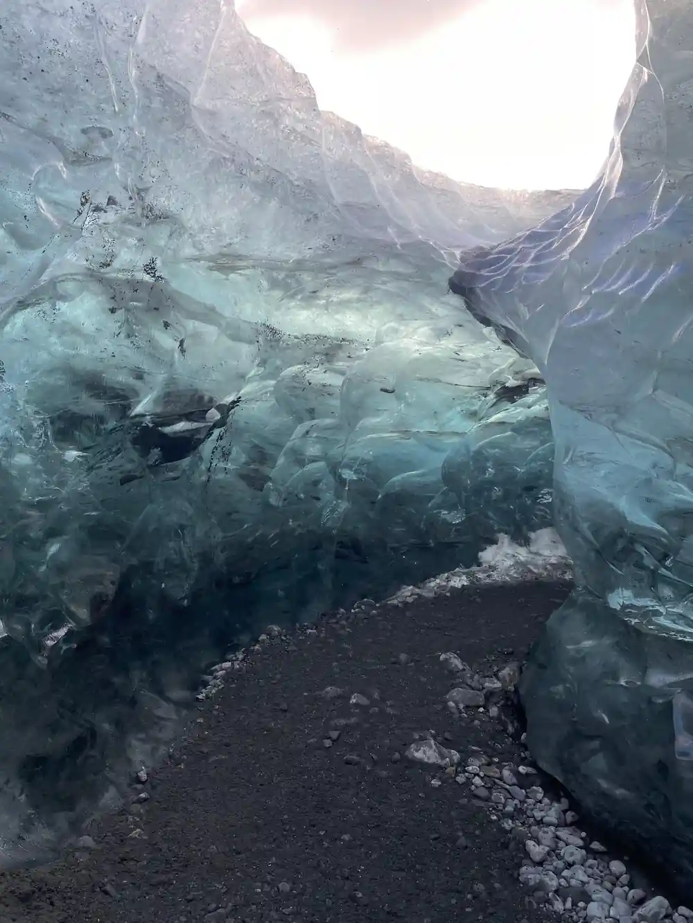 Ice cave ceiling opening with bright light above