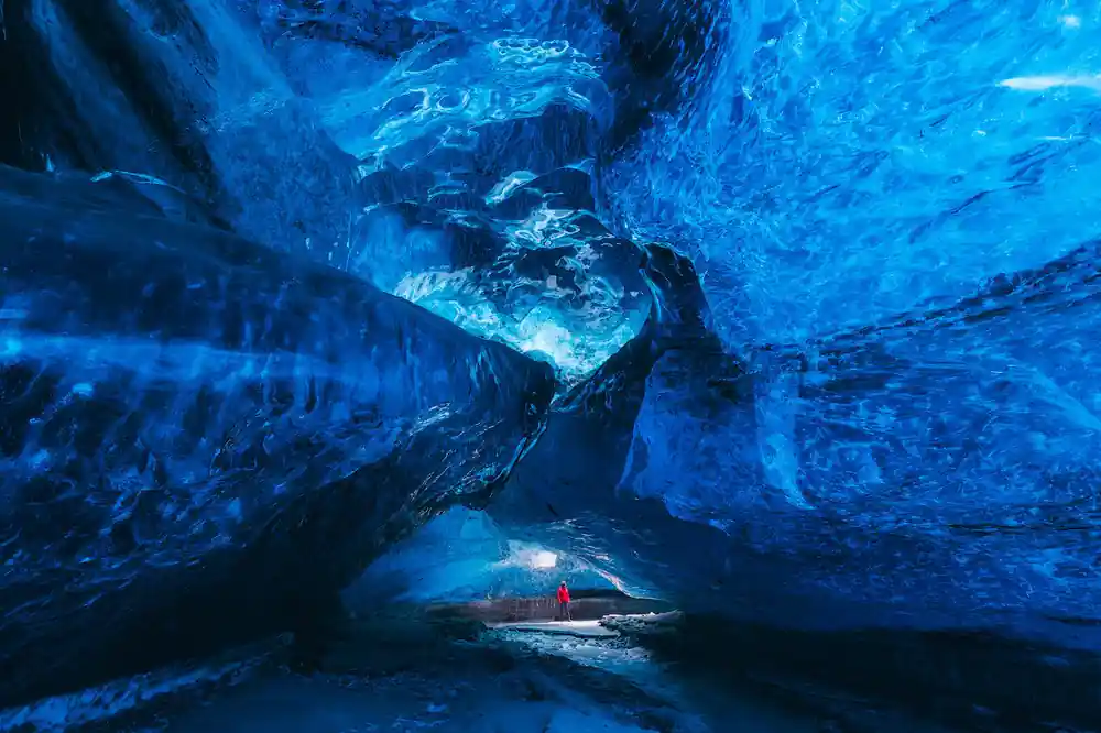 Interior of blue ice cave with frozen formations