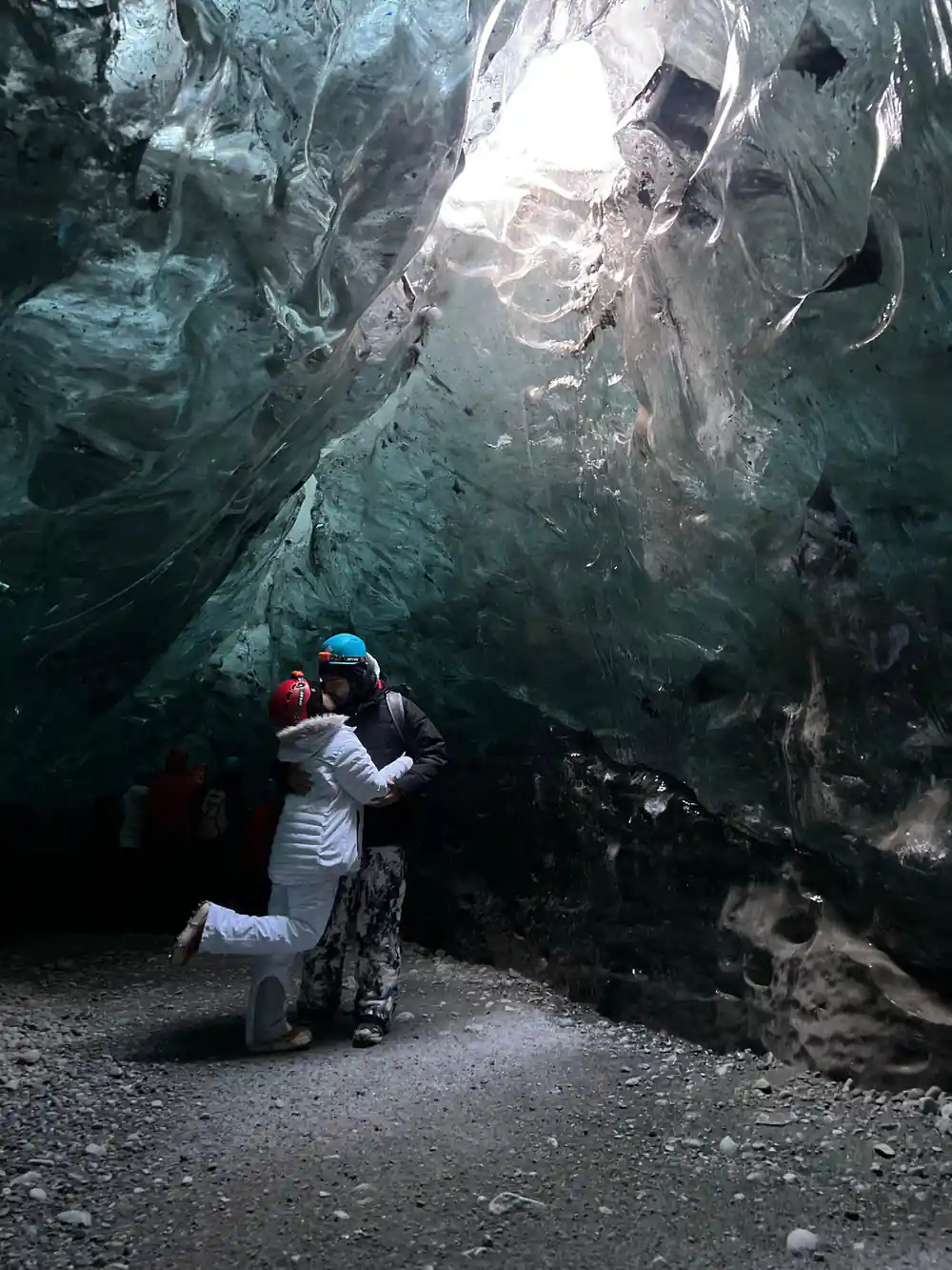 Person standing inside enormous ice cave chamber
