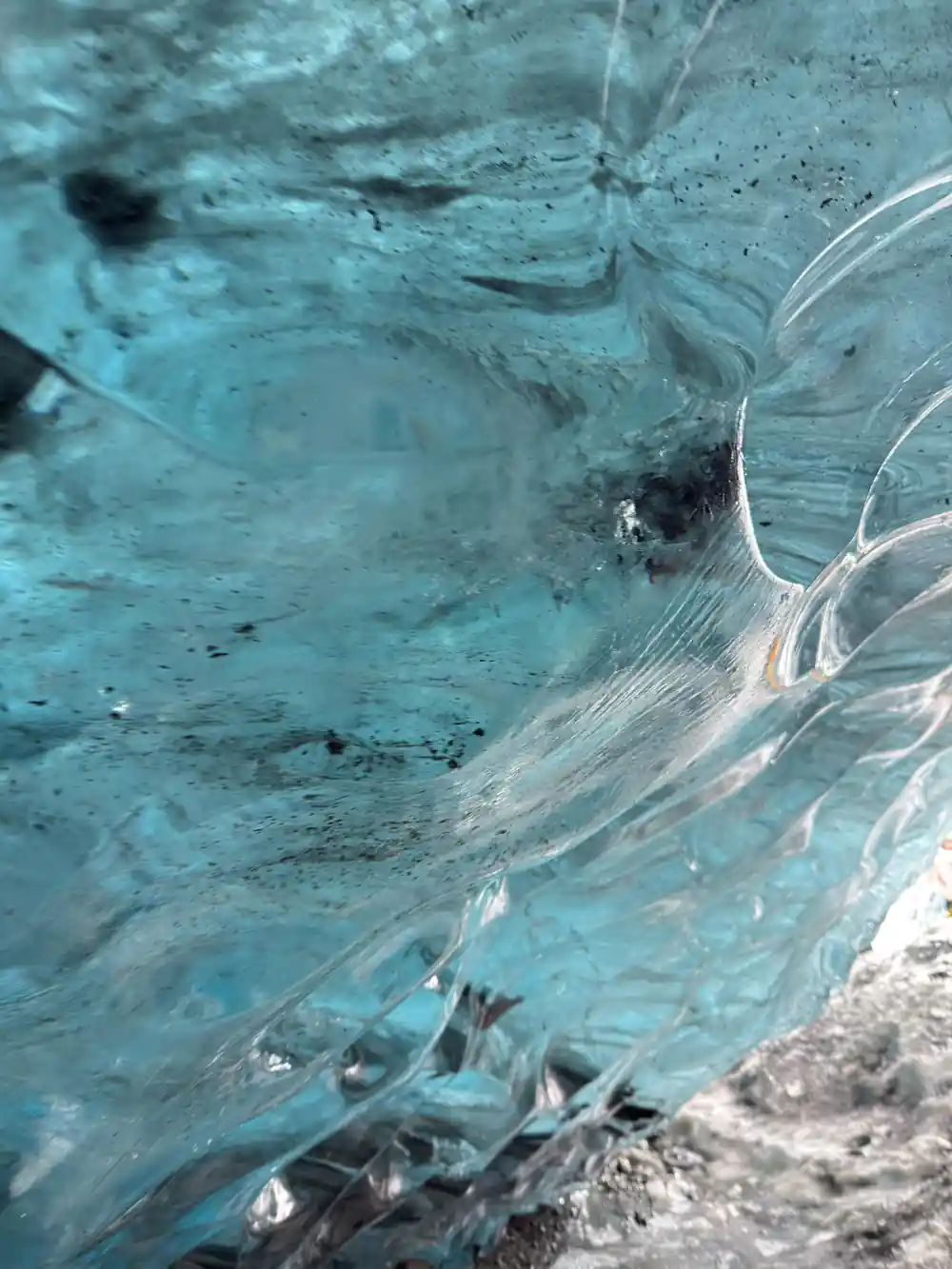 Swirling patterns in translucent blue glacial ice