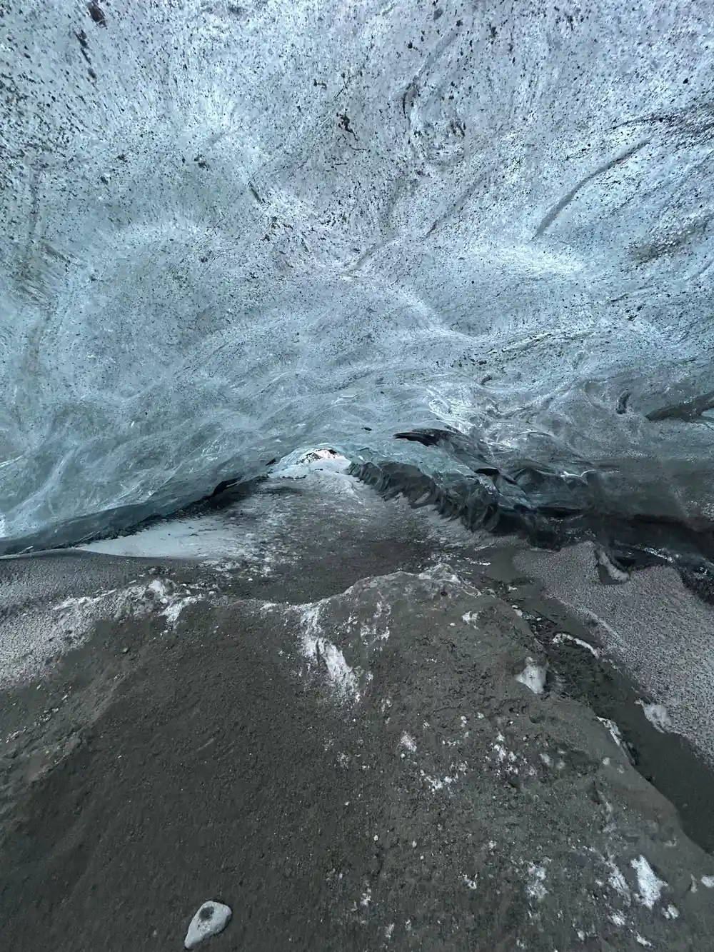 Textured ice floor beneath pale blue ice walls