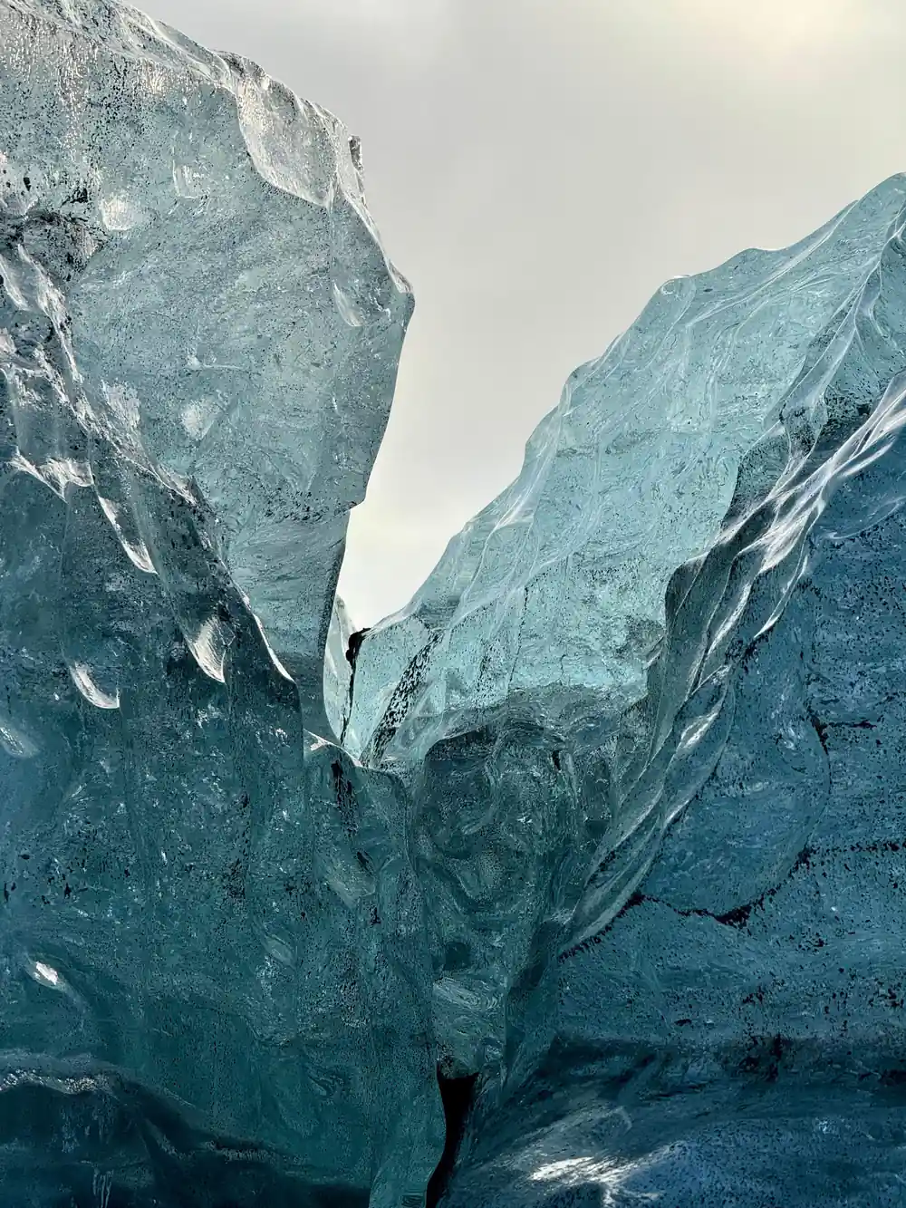Towering turquoise glacier walls forming narrow passage